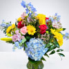 This vibrant arrangement bursts with color and charm, featuring radiant yellow daisies