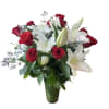 Dozen red roses and white lilies designed in a tall glass vase.