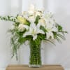 White Casablanca lilies complimented by 12 stunning white roses and seasonal greens