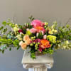 This exquisite floral arrangement is both graceful &amp; charming.  A pedestal