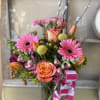 Soft pinks, peach tones, and fresh seasonal blooms come together in this