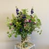 A wildflower style arrangement with free-flowing, organic florals. Same day delivery to