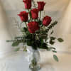 A gorgeous arrangement of 6 roses in a beautiful glass vase. Perfect
