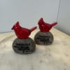 Cardinal perched on a stone with the saying "Cardinals appear when angels