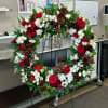 A timeless expression of love and remembrance, this standing wreath features a
