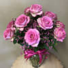 One dozen pink roses matched perfectly with a coordinated bow, filler flowers