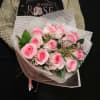 A classic one dozen pink roses with pink/white wax flowers.