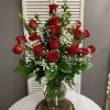 Two Dozen Red Roses Arranged in a Vase with a filler flower