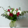 The contrast of creamy white and rich red tulips creates a look
