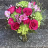 This arrangement has green hydrangeas, roses, alstroemeria, hypericum, carnations and beautiful greenery