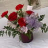 Mixed bouquet of red roses, filler and greens 