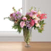 A grand and modern asymmetrical floral design in a tall glass fluted