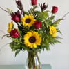 A sensational arrangement of buttery sunflowers, scarlet roses accented with solidago and