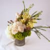 A garden look arrangement of pastel palettes in rustic tin can. Medium-high