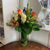 Orange roses, yellow stock, orange lilies, iris, orange alstromeria arranged in a
