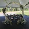 A beautifully styled floral arch designed with soft blooms and flowing greenery