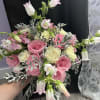 A lush garden-style bridal bouquet featuring delicate blush pink blooms blended with