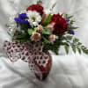 Red carnations, white daisies, pink alstromeria, &amp; purple statice
