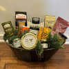 An assortment of high-quality gourmet items artfully presented in a basket, perfect