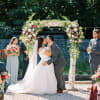 A refined floral arch arrangement that transforms the ceremony space into an