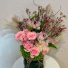 A refined arrangement of soft pink blooms designed to captivate at first