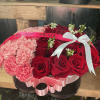 This beautiful heart is made of red roses and baby pink carnations