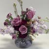 Seasonal mixture of florals in soft lavenders and purples . 