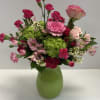 Bright seasonal mixture of hot pinks and light pink flowers in bright