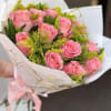 Classic wrapped arrangement of pink roses and greeneries filled with our unique