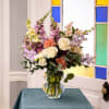 Garden Celebration is a vibrant, garden-style floral arrangement created to mark meaningful