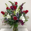 Roses, lilies, snapdragons with daises, wax flower, etc.

Flowers and color may vary