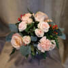 A cheerful blend of soft peach and pink blooms in a white