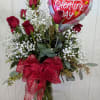 One dozen red roses classically arranged with babies breath, bow and a
