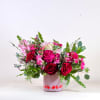 A charming and romantic floral arrangement designed in a soft blush vase