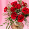 One dozen garden roses are delivered in a beautiful glass vase. 