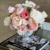 A soft blend of blooms, including Roses, Garden Roses, Peonies, Tulips, and