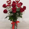 A beautiful Valentine&rsquo;s arrangement featuring 12 fresh red roses, gracefully complemented with