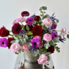 Elegant Valentine's Day flower arrangement of premium red roses, red/burgundy cremons and