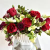 Stunning lush flower arrangement with premium Red Heart roses, hellebore, cremons and