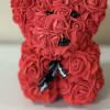 A luxury bear made with faux rose blooms in shades of red