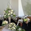 Tall centerpieces with cascading greenery and premium blooms for dramatic impact.