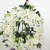 A graceful wreath of soft white and gentle pastel blooms, accented with