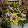 A mixture of yellow and lavender daisies, pink carnations, yellow snap dragons
