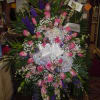 A mixture of purple larkspur, pink larkspur, medium pink roses, white hydrangea