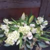 Lilies, roses, other fresh, seasonal flowers in white. Makes a great gift
