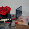 18 red roses and 42 chocolates in a black luxury heart display