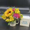 Bright seasonal flowers will be arranged in our 14oz ceramic mug .