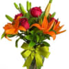 A bright and cheerful floral arrangement featuring vibrant orange lilies, fresh roses