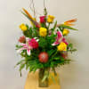 This Mixed Tropical Arrangement includes Birds of Paradise, Pincushions, Yellow Roses, Hot