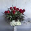 * Stunning tall vase filled with white hydrangeas, a dozen long red